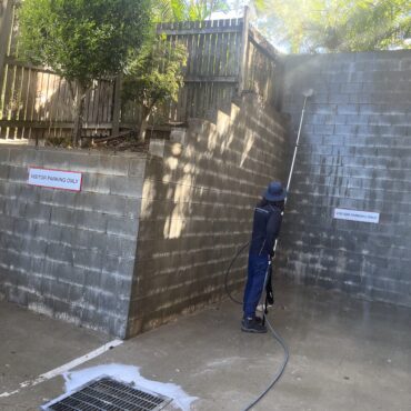 Pressure washing brick retaining wall
